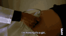 a pregnant woman is getting an ultrasound from a doctor and says i 'm thinking it 's a girl