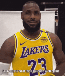 lebron james is wearing a yellow lakers jersey with the number 23 on it