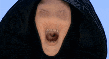 a close up of a person 's face with a black hood on