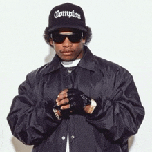 a man wearing a compton hat and a black jacket
