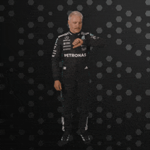 a blurred image of a person wearing a suit that says ' ferrari ' on the side