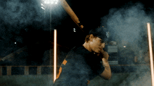 a baseball player with the number 5 on his back is holding a bat