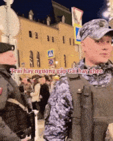 a man in a military uniform stands next to another man with the words trai hay nguong gap gai hay gheo