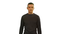 a man wearing a black shirt is making a fist gesture