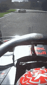 a red bull race car is going down a track