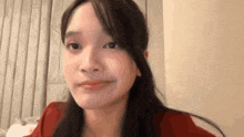 a close up of a woman making a funny face while looking at the camera .