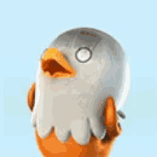 a stuffed bird with a yellow beak and a gray head is looking at the camera .