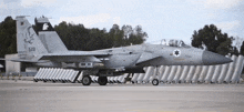 a gray fighter jet with the number 519 on the tail
