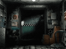 a dark room with a few posters on the wall one of which says kad