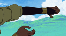 a person 's arm is shown in front of a green field