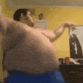 a man is dancing in front of a picture of a man in a suit and tie