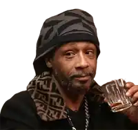 a man wearing a fendi scarf is holding a glass of alcohol