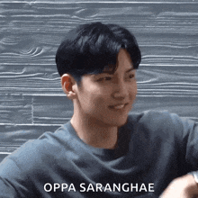 a close up of a man 's face with the words oppa saranghae written on the bottom