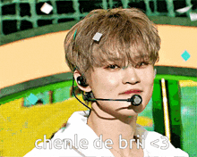 a young man wearing a headset with the words chenle de brii < 3 written below him