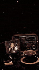a lg radio sits next to a cd that says the best