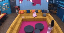 a woman is standing in a room with a large couch