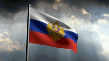 a russian flag is flying in the wind with a cloudy sky in the background