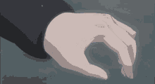 a person 's hand is reaching out towards something