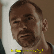 a close up of a man 's face with the words is that one moving behind him