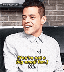 a man in a gray shirt is laughing and saying `` you 're not a big emoji fan . ''