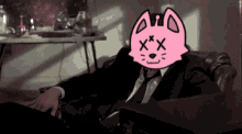 a man in a suit and tie has a pink cat face on his face