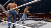 two wrestlers in a wrestling ring with a sign that says wrestle