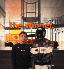 a man wearing a optimum nutrition jacket stands next to another man