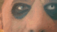 a close up of an elderly man 's face with a mustache on it .