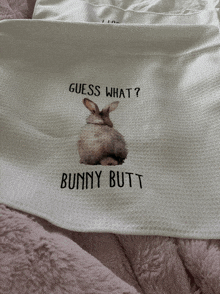 a white cloth with a picture of a bunny and the words " guess what bunny butt "