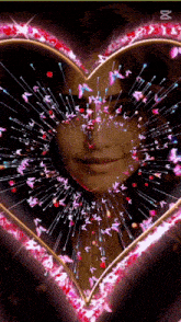 a woman 's face is surrounded by a heart of butterflies and sparkles