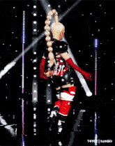 a woman in a red white and blue outfit is dancing on a stage