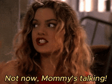 a woman says " not now mommy 's talking " in yellow