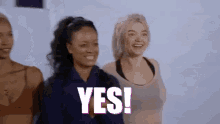 a group of women are standing next to each other and one of them is smiling and says yes .