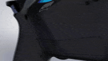a close up of a black suit with a cell phone in the pocket .
