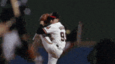 a man in a ny yankees uniform is about to swing at a ball