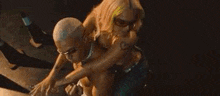 a group of people are dancing together in a dark room in a blurry photo .