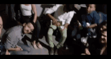 a group of people are sitting in a circle on the ground .