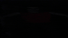 a man wearing a red shirt is smiling and looking at the camera