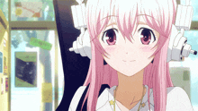 a girl with pink hair is wearing headphones and looking at the camera