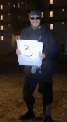a man holding a piece of paper with the number 3 written on it
