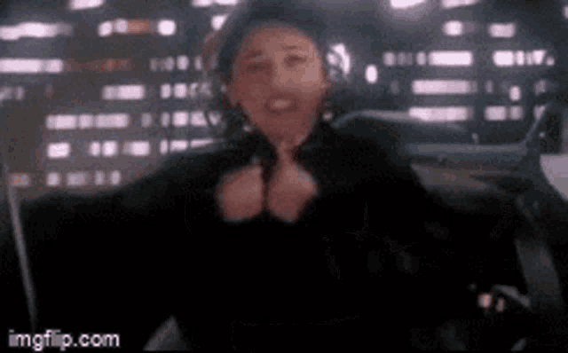 a blurry picture of a woman giving a thumbs up sign