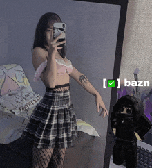 a girl taking a picture of herself in front of a mirror with the letters bazn on it