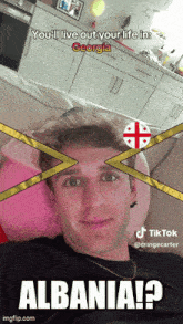 a man is laying on a couch with a georgia flag on his face