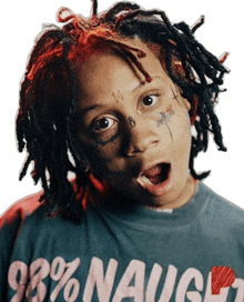a young man with dreadlocks is wearing a t-shirt that says 98 % naught