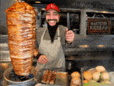 a man with a beard is holding a knife in front of a sign that says mastster kebab