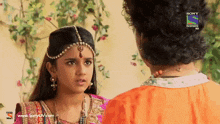 a man and a girl are looking at each other on a sony television hd screen