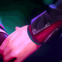 a close up of a person holding another person 's hand with a purple and blue background