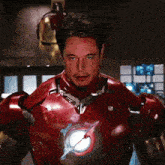 a man in a red iron man suit stands in front of a wall