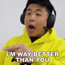a man wearing headphones and a yellow hoodie is saying i 'm way better than you