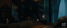 a fox kids ad shows a dinosaur in a dark room